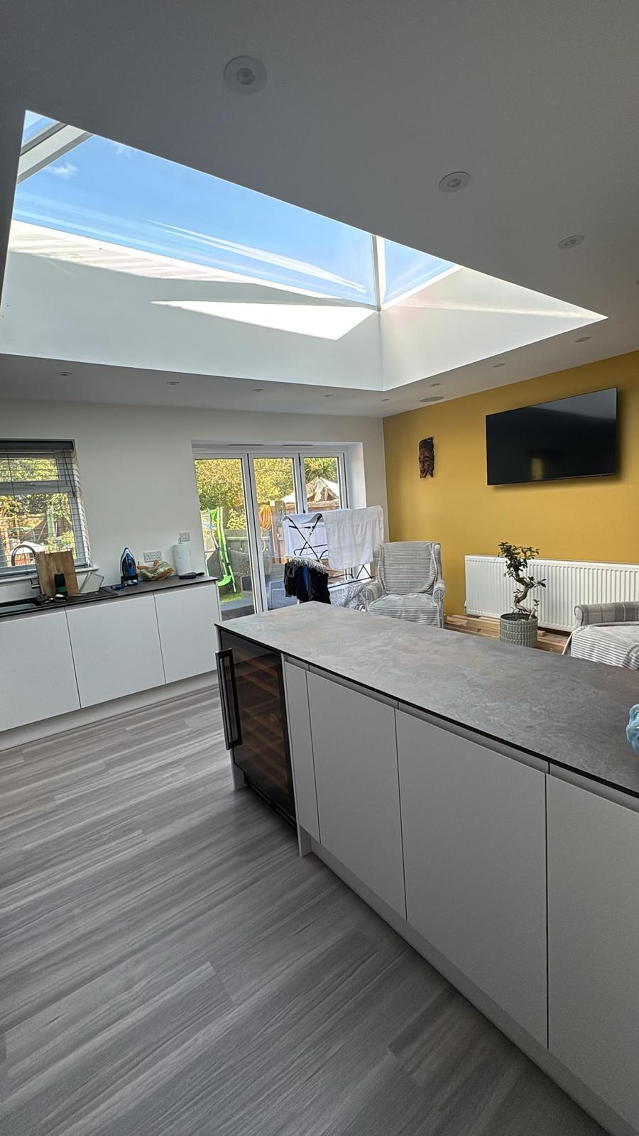Photograph — open-plan kitchen and dining space with island and bifold doors, 4m rear extension, Leicester