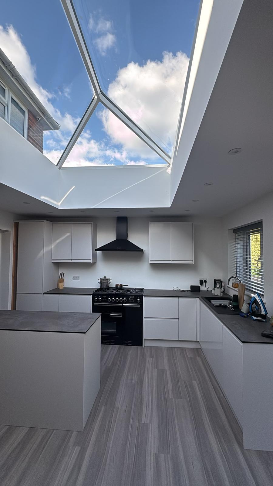 Photograph — finished kitchen beneath the roof lantern, 4m rear extension, Leicester