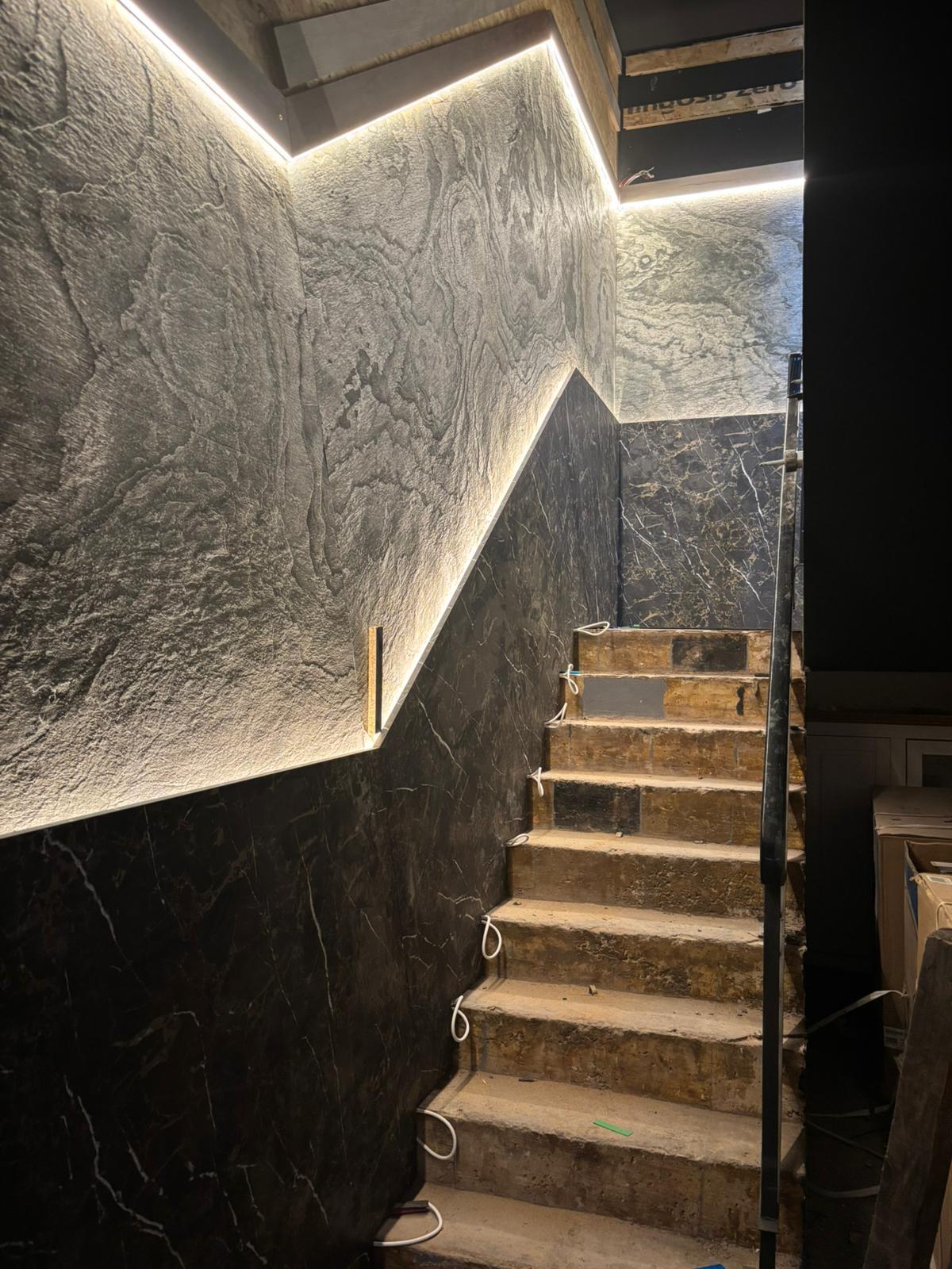Work in progress — staircase with textured stone feature wall and LED strip lighting, Café interior fit-out, Birmingham